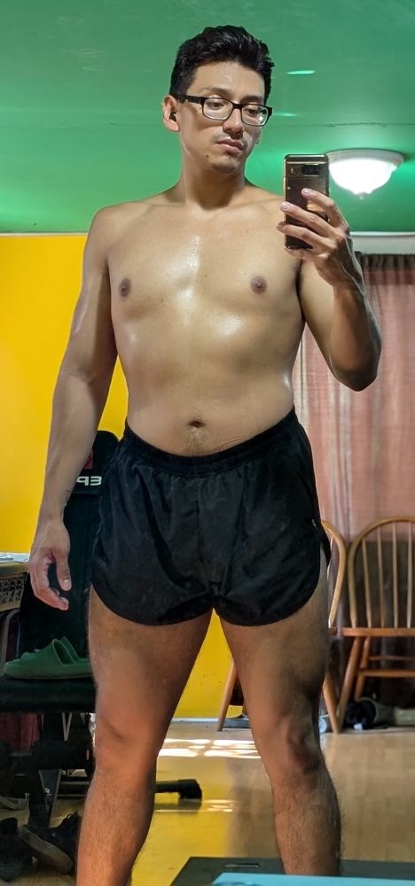 Me shirtless wearing a black pair of loose running shorts 