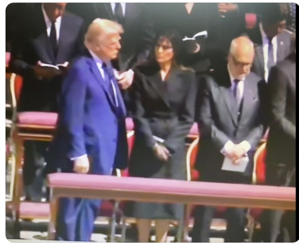 A picture from the funeral of the pope, with trump wearing a blue suit and everybody else, including Melania, wearing black.