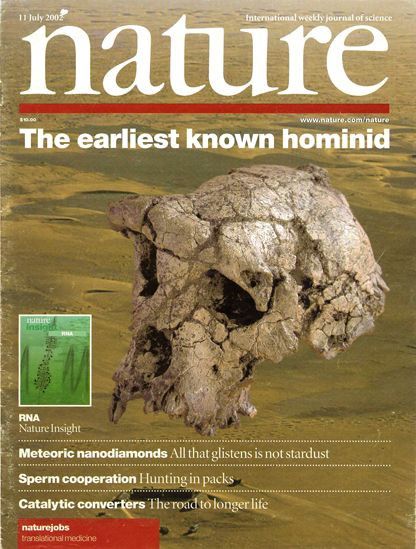 Cover of the 11 July 2002 issue of Nature magazine. The headline reads "The earliest known hominid" above a photograph of a fossilized hominid skull (Sahelanthropus tchadensis) partially embedded in sand or sediment. Other cover stories listed include: "RNA," "Meteoric nanodiamonds: All that glistens is not stardust." The cover background is a golden-brown tone.