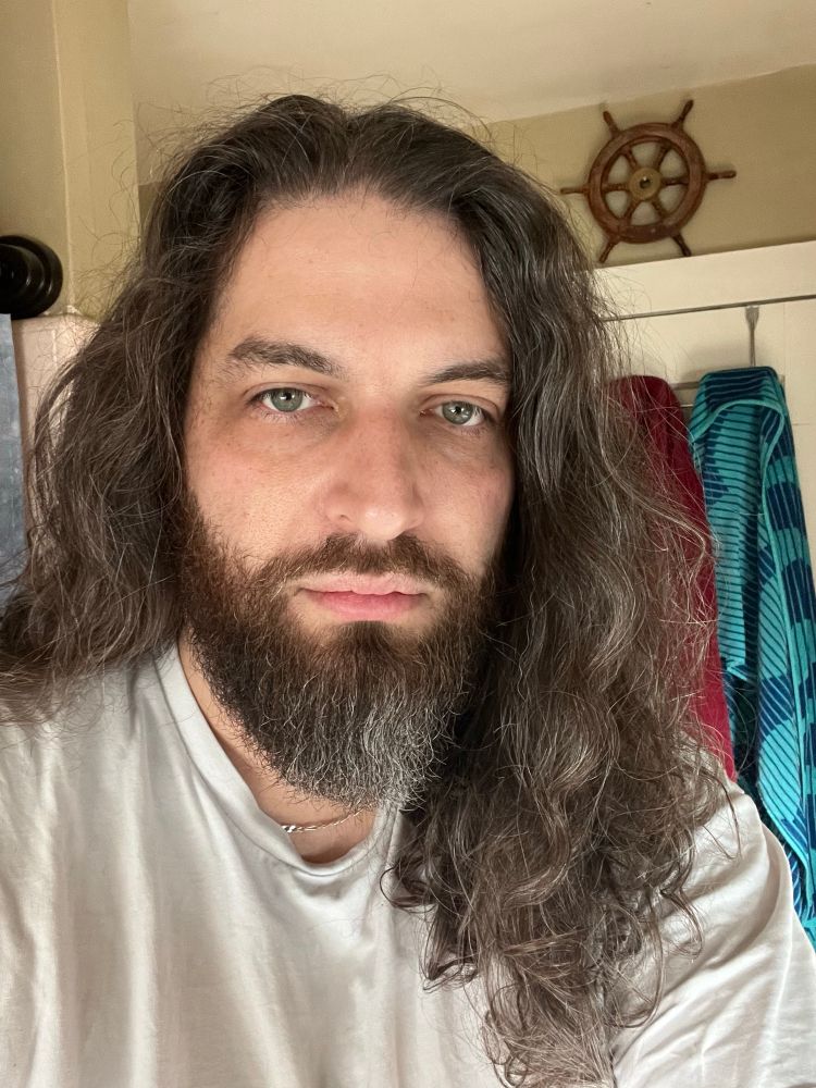 Some white guy with long brown and silver hair, with a beard to match, took a selfie this morning by staring dead into the camera, dead behind the eyes, just because his bathroom lighting was good. 