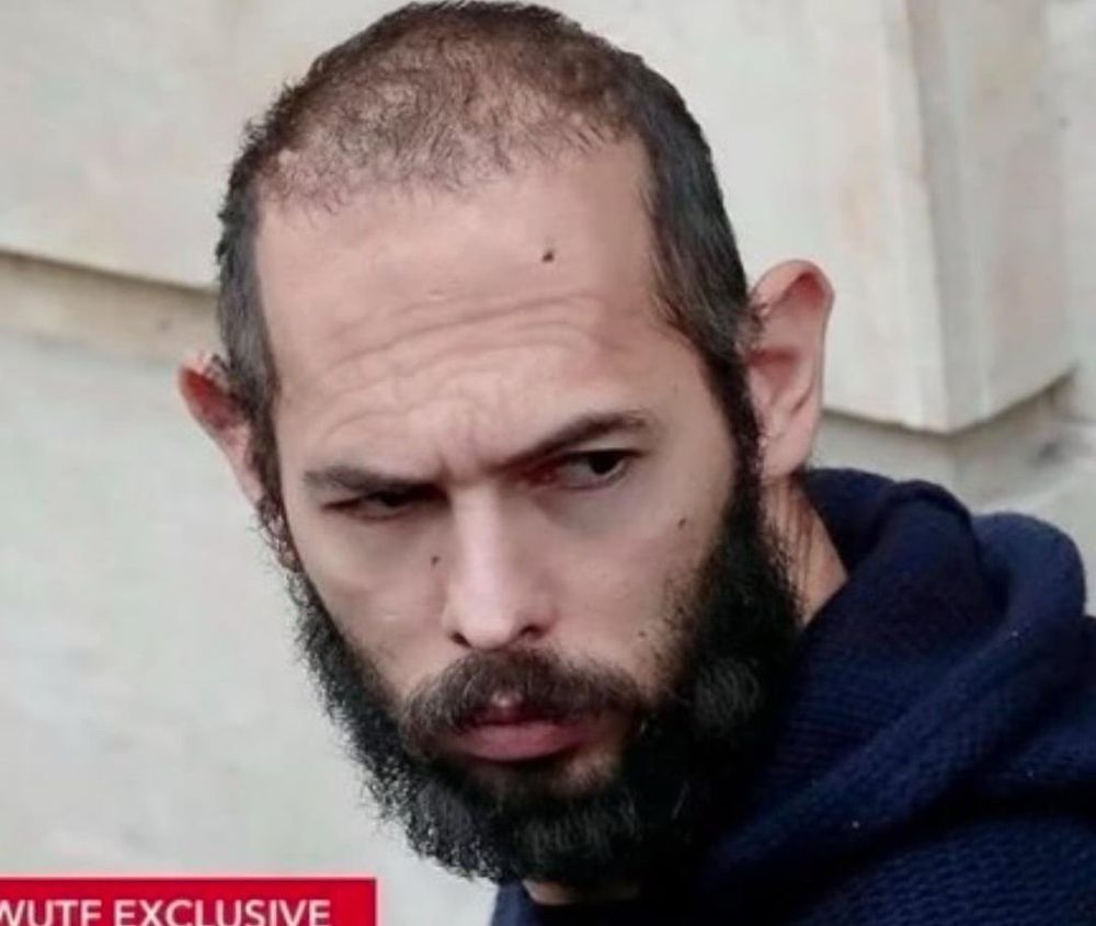 Andrew Tate, scraggly and looking like he got banned from the McDonald’s dumpster, being surly as hell. 