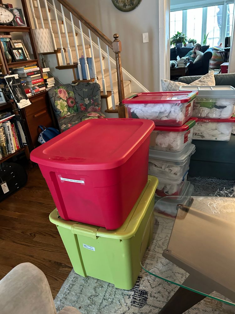 A bunch of plastic bins full of Christmas decorations