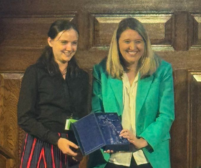 Chloé François-Oatway is presented with the 2025 FDA Wendy Jones Equality Award by Parliamentary Secretary for the Cabinet Office Georgia Gould MP at the FDA Annual Delegate Conference 2025. 