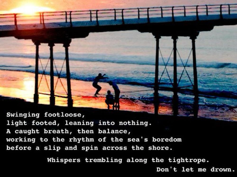 Tide rolling between a set of pier legs in the sunset. A tightrope strung between two of them. Three people. One balancing and attempting to walk the tightrope, the other two watching.