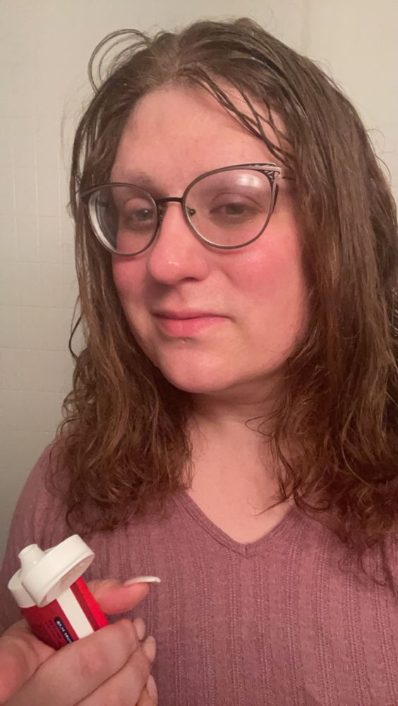 a selfie of me holding toothpaste