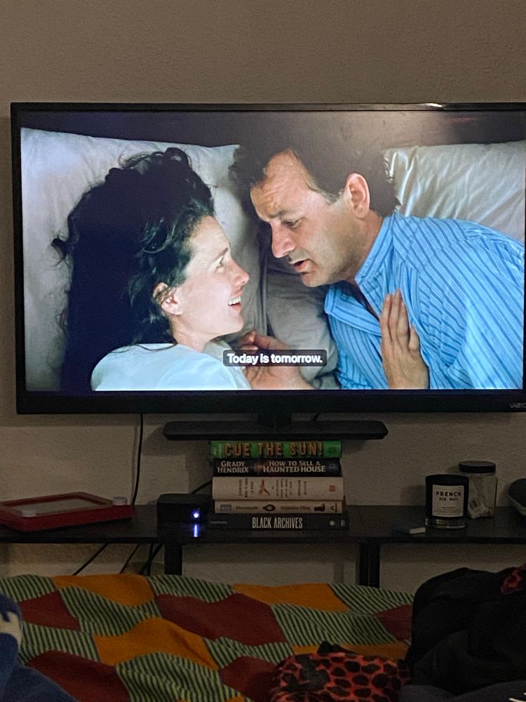 Picture of the film “Groundhog Day” on a television. Bill Murray says to Andie McDowell “Today is tomorrow.”