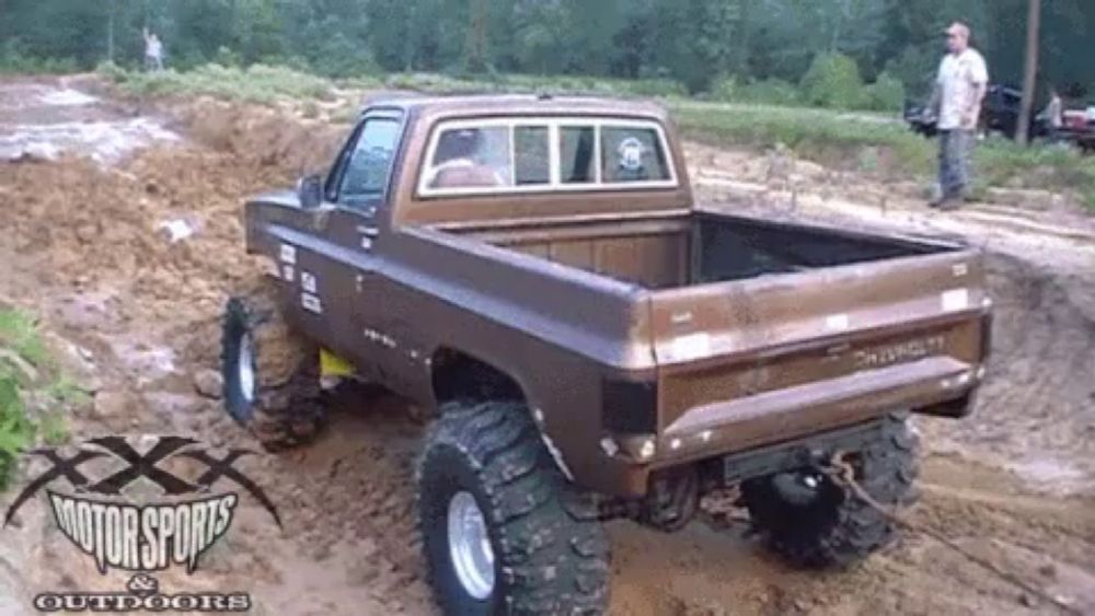 a chevrolet truck is driving through a muddy field sponsored by xxx motorsports and outdoors