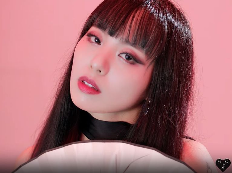 Close up of Arem holding the white fan. 