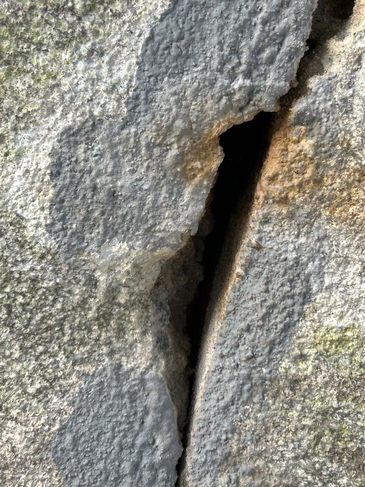 A small dark crevice in concrete 