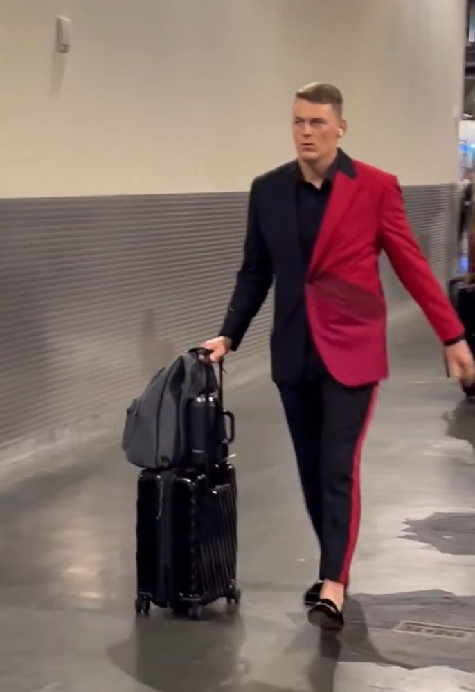 Mac Jones in what looks like a Harley Quinn from Batman: The Animated Series costume turned into a fitted suit