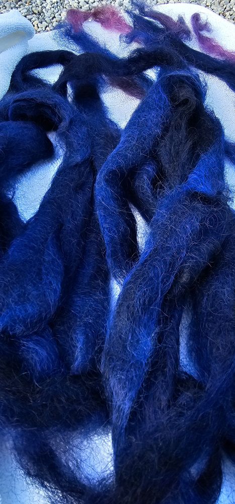 Midnight blue wool roving atop a white terry towel
