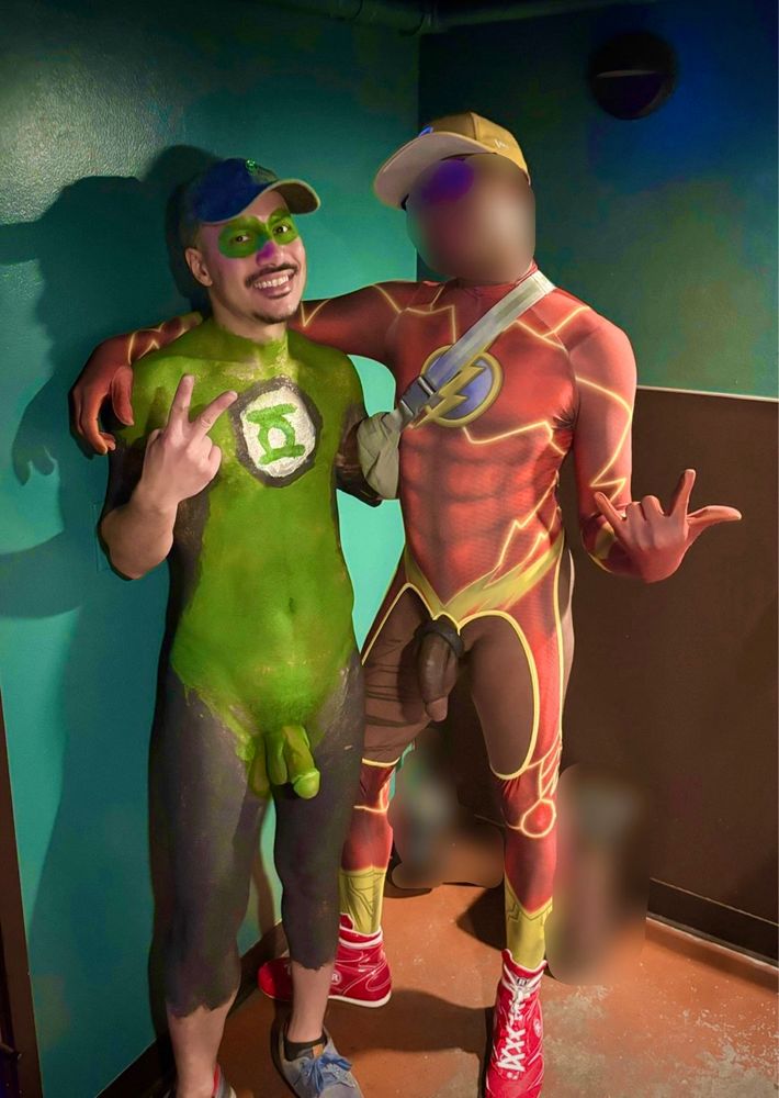 Friend and I nude at a bar. I’m covered in Green Lantern body paint, while he’s rocking a Flash outfit that leaves nothing to the imagination.