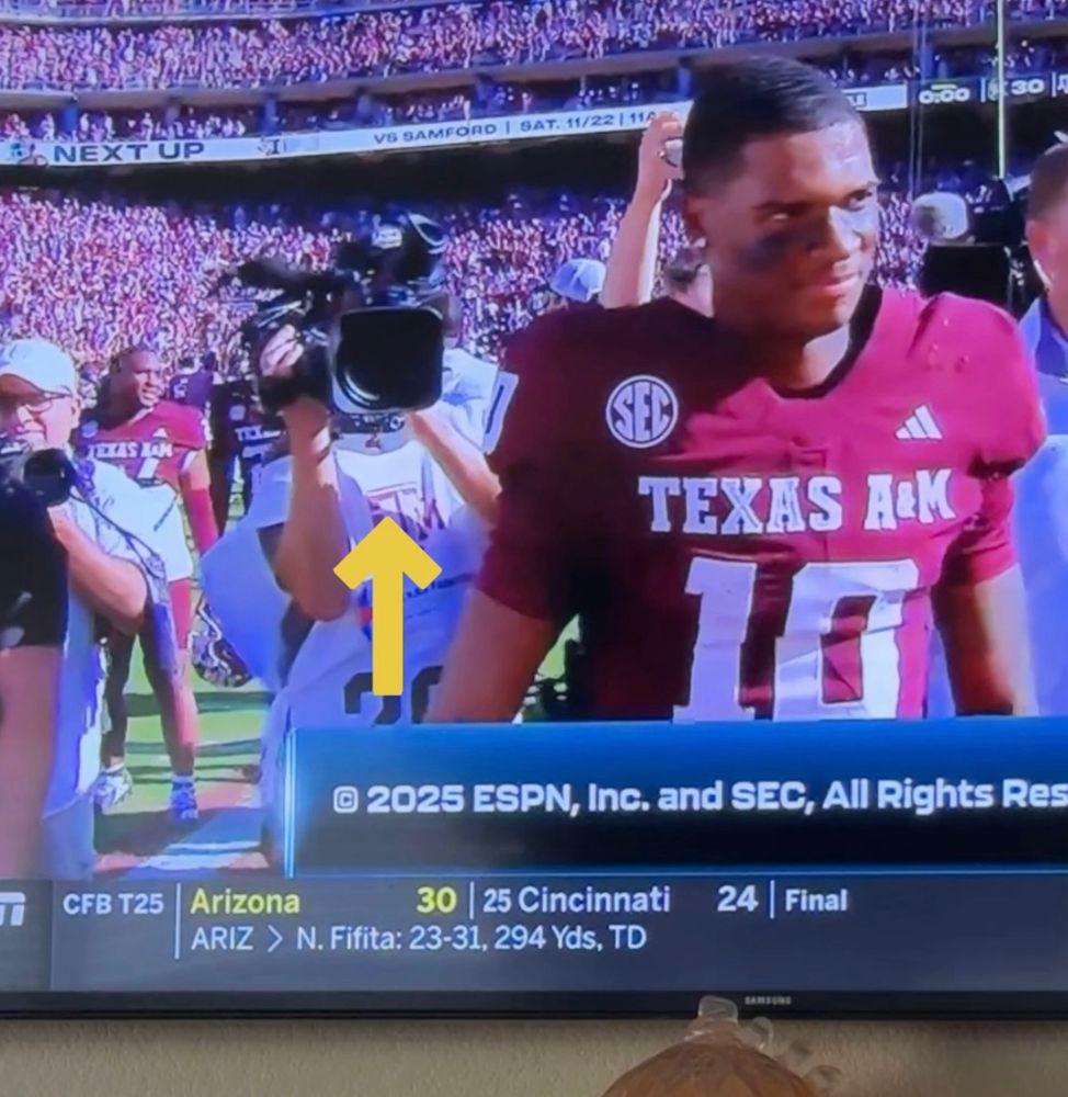 Alanis’ husband on tv filming Marcel Reed of Texas A&M