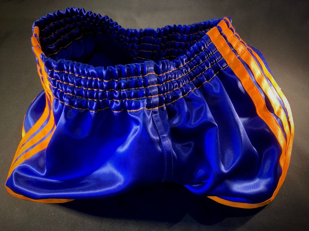 Homemade shorts in royal blue with orange trim and stripes 