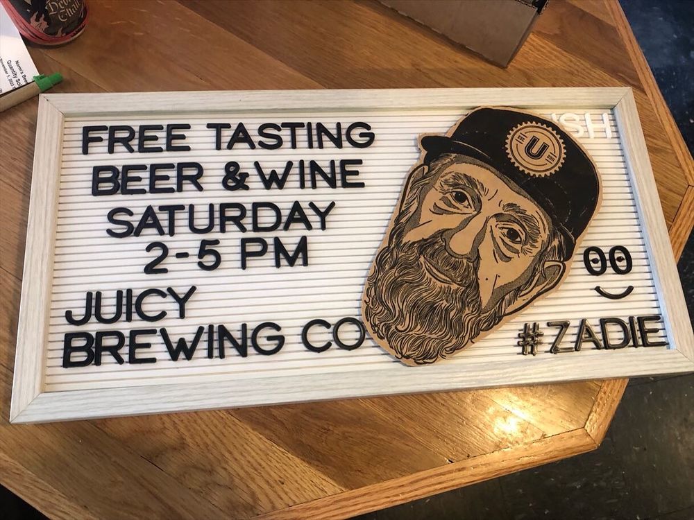 Sign promoting free beer/wine tasting at Norm’s Beer & Wine in Vienna, VA from 2-5 PM. November 11, 2023