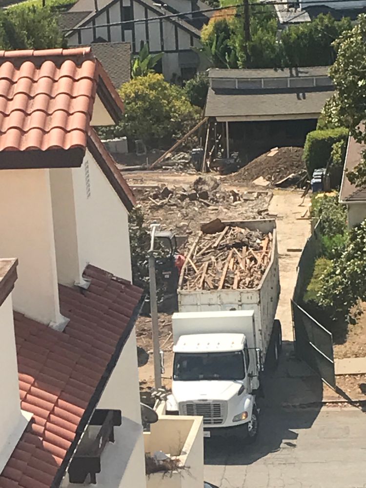 A white big rig truck, leaving a lot on a residential street, hauling an open top trailer full of the brown debris of a house that was torn down. (It was 3+2 with a separate garage - still standing  in the upper right of the lot - built in 1931, rented out for the last 20+ years, died 7/30/25.)
RIP my quiet neighborhood as construction will last 3 -5 years.
