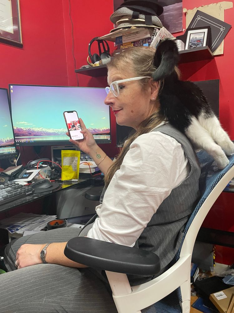 I’m sitting in my office chair looking bemused because Sylvie, a tuxedo cat, is leaning into my back and shoulders 