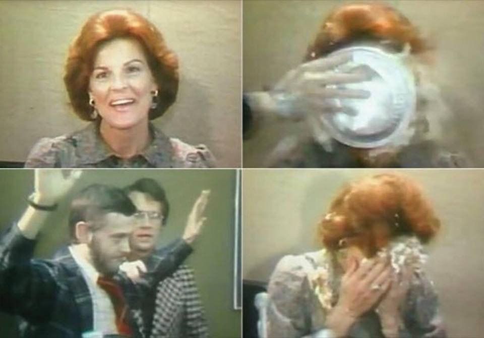 Four-panel sequence from a news archive showing a woman getting a custard cream pie smushed in her face, with one panel showing the man who had applied the pie.