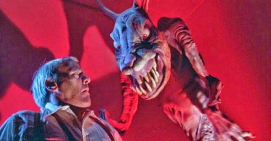 Scene from the Twlight Zone Movie, depicting the rabbit trick. A man is in the bottom left of the frame, while a monstrous giant hairless rabbit with fangs dominates the right side of the frame, they are lit with an unnatural red light