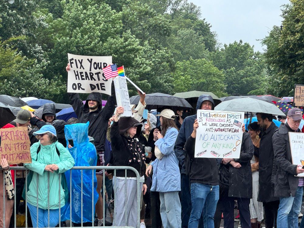 protester with a sign reading “fix your hearts or die.”