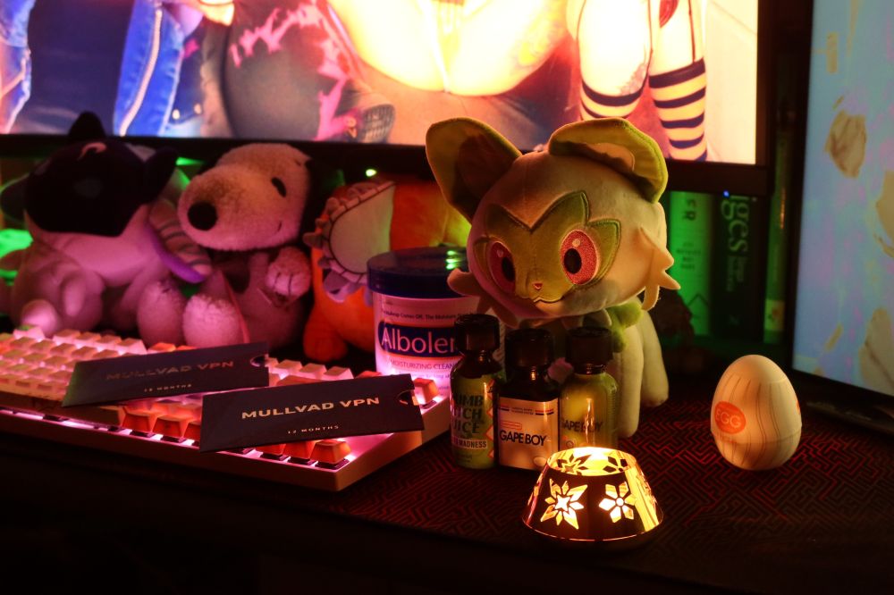 Candle lit desk with mullvad vpn, albolene, poppers and an egg! 