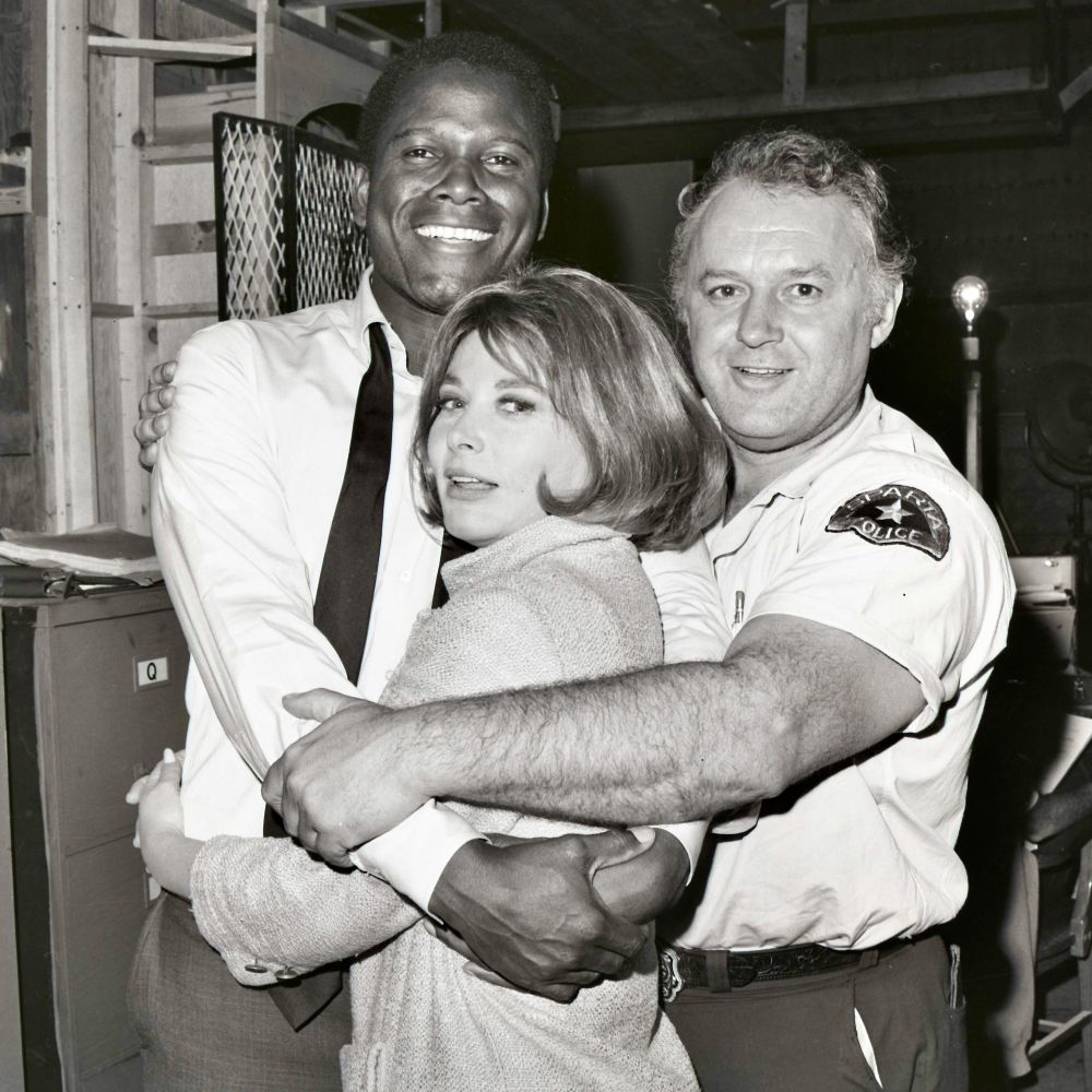 Oscar winner Rod Steiger (in costume as Chief Bill Gillespie) embracing Sidney Poitier and Lee Grant.