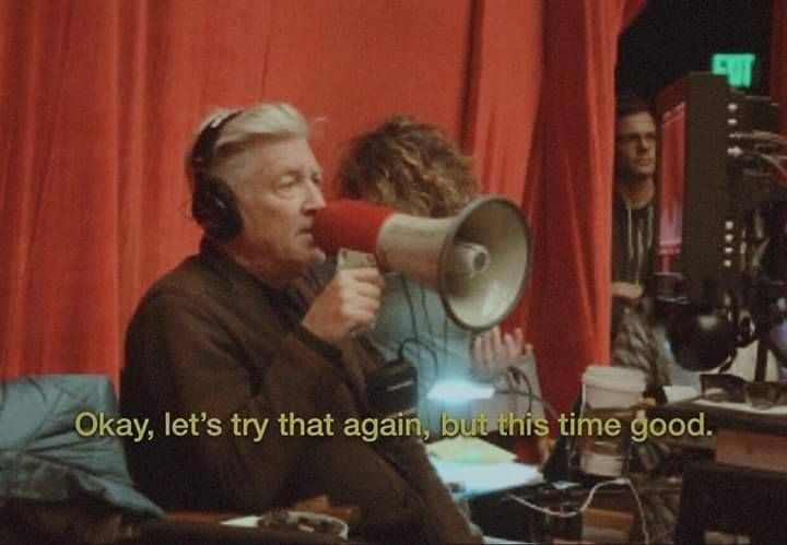 David Lynch on set holding a megaphone and telling the cast, "Okay, let's try that again, but this time good."