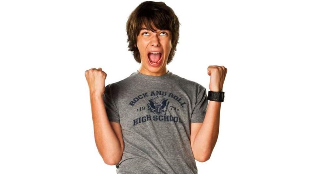 Rodrick Heffley from the Diary of a Wimpy Kid movie cheering in ecstasy with both fists raised 