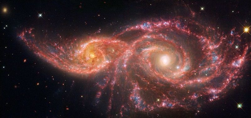 Galaxy IC 2163 “creeping” behind Galaxy NGC 2207