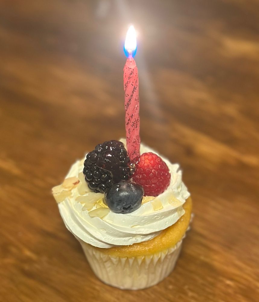 A chantilly cupcake with a pink candle to celebrate my birthday today. I also share a birthday with Chappell roan which is infinitely beautiful. Pisces queens. 