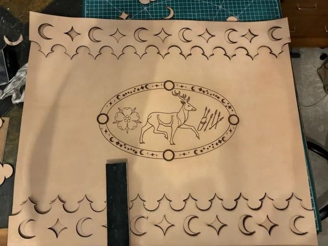 star & moon border with celestial stag flanked by rose and arrows. 