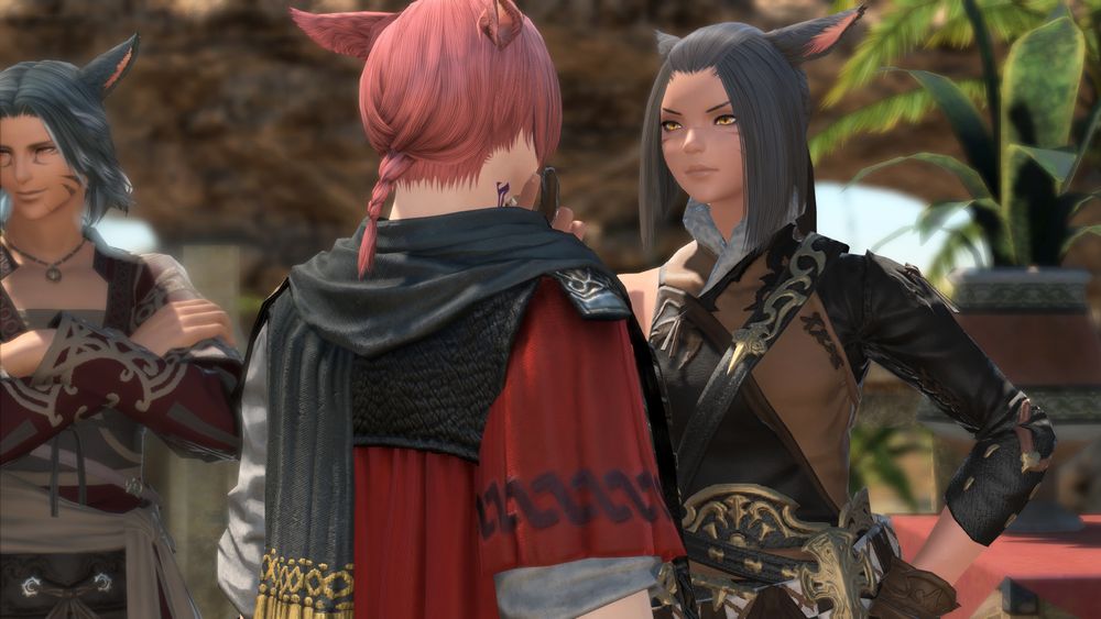 l'thena's mother holds g'raha firmly by the chin and inspects him with an intense, unimpressed look. her husband is farther back, smiling off to the side and unconcerned about any of this.