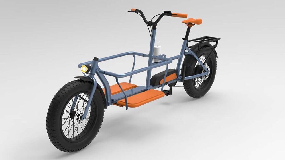 An orange and grey cargo bicycle, it has a large cargo bay in front that stretches the front wheel further from the handle bars, with enough space to hold a person.

It appears to have an electric motor to support the driving.