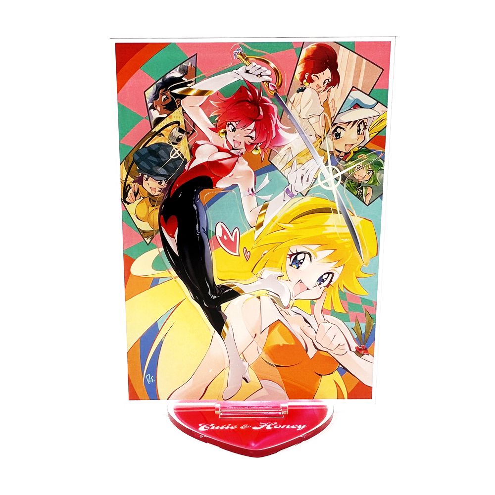 Photograph of an acrylic stand against a white background. The stand is rectangular in design on a love heart base. The art is by Araizumi Rui (original Slayers novel illustrator) and features all versions of Cutie Honey from the original Cutie Honey series. Cutie Honey herself pops out in a black and red outfit, she winks while clutching her sword. The backdrop features all her other forms posing in their iconic outfits.