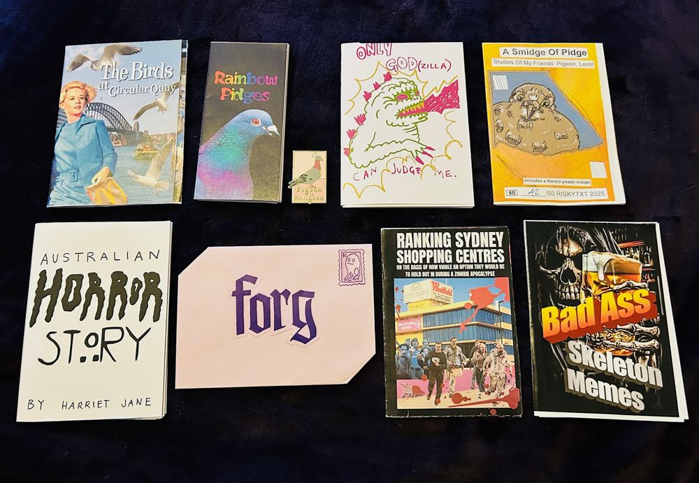 Photo of various locally produced zines from Sydney, Australia's Halloween Zine Spooktacular 2025. Pictured are various small colourful leaflets featuring unique illustrations and designs.