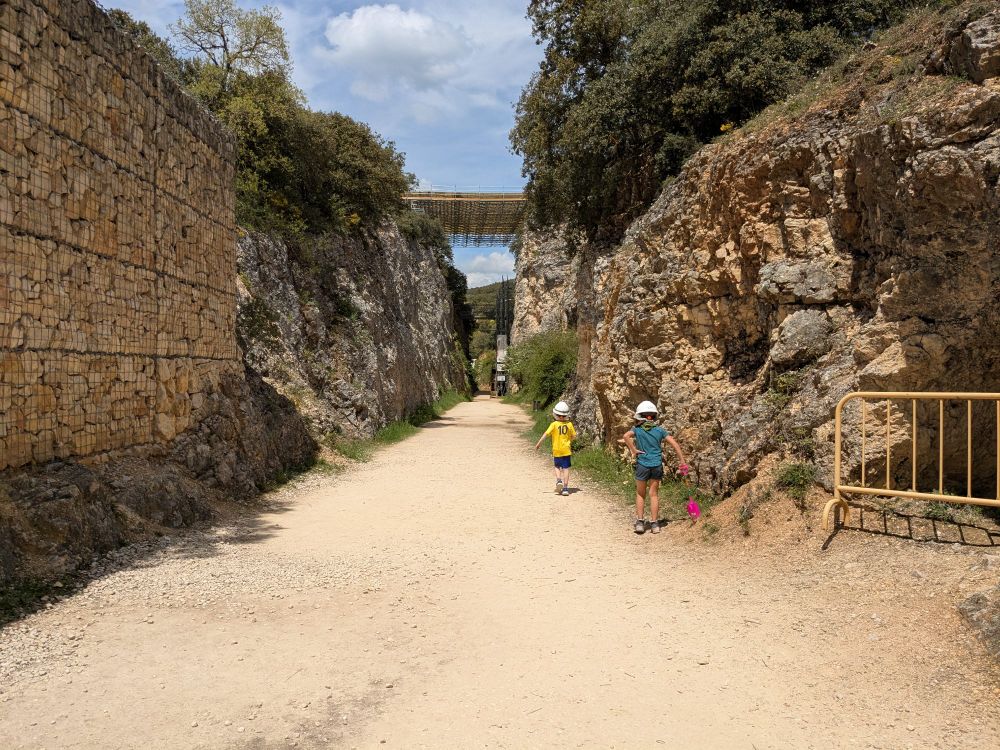 Two kids running down the railway trench at Atapuerca