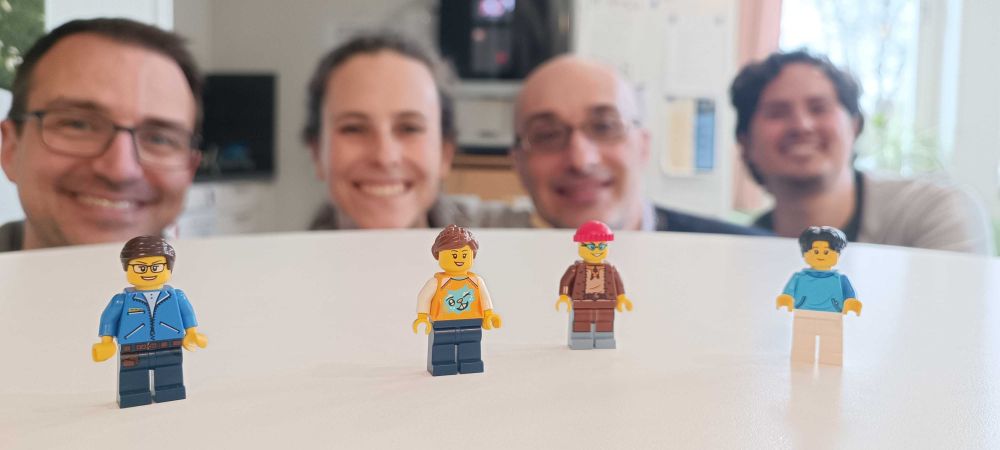 A group of scientists posing behind their Lego alter egos 