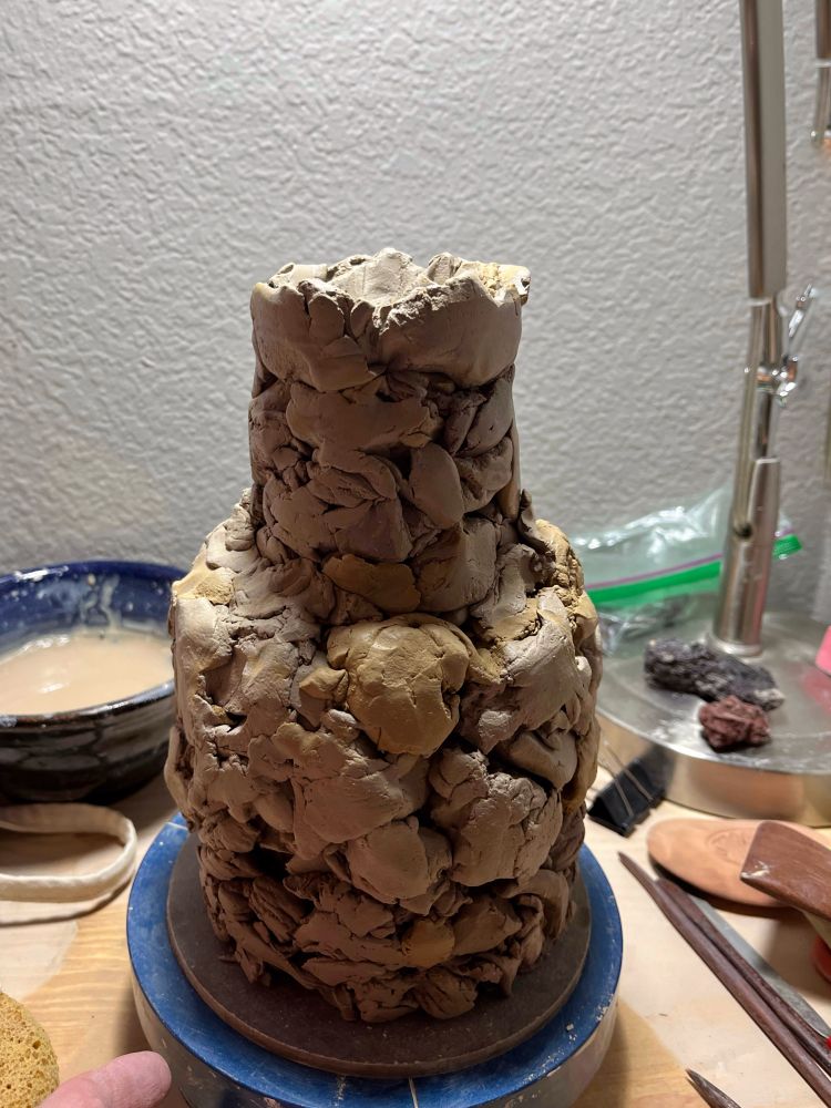 An inexplicable stoneware bottle made from multiple clays with an organic stony texture