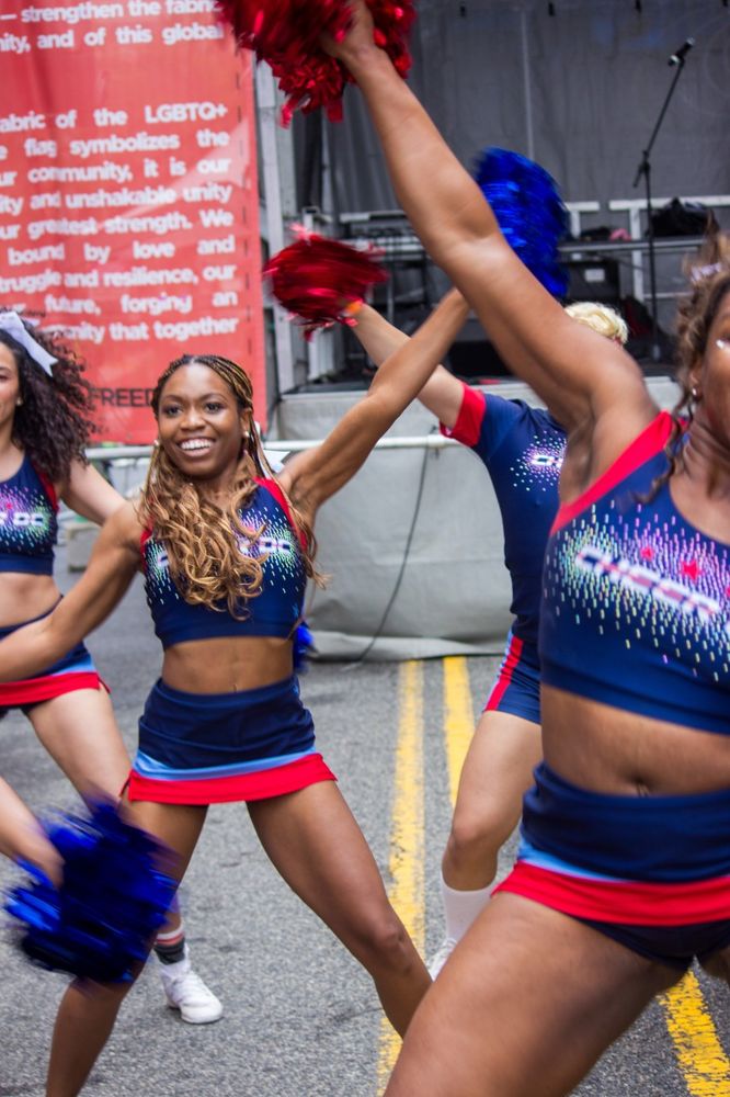 Charitable cheerleaders perform a pom dance routine at DuPont Stage during WorldPride 2026.