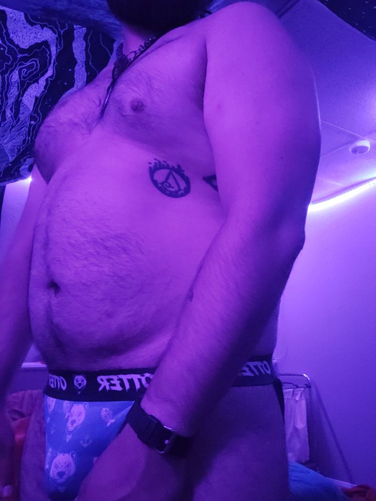 Masculine presenting person wearing only a jock showing off body. Mid Thigh up 