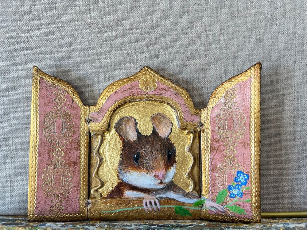 An icon of a mouse holding a sprig of speedwell 