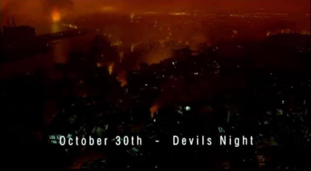 The opening image of The Crow (1994), Dir: Alex Proyas. A bird’s eye (crow’s eye) view shows Detroit on fire after numerous arson attacks. The text on screen reads “October 30th - Devils Night.”