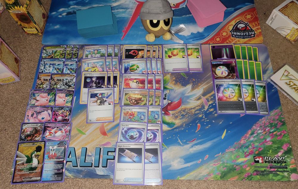 Ogerpon Box!

Pokémon: 15
3 Teal Mask Ogerpon ex TWM 25
2 Wellspring Mask Ogerpon ex TWM 64
2 Cornerstone Mask Ogerpon ex TWM 112
2 Lillie's Clefairy ex JTG 56
1 Mew ex MEW 151
1 Fezandipiti ex SFA 38
1 Latias ex SSP 76 
1 Bloodmoon Ursaluna ex TWM 141
1 Iron Bundle PR-SV 58
1 Squawkabilly ex PAF 75

Trainer: 32
3 Professor's Research PRE 125
3 Boss's Orders PAL 172
3 Iono PAF 80
1 Penny SVI 183
4 Energy Switch SF 84
4 Nest Ball SUM 123
3 Earthen Vessel PAR 163
3 Ultra Ball SLG 68
2 Night Stretcher SFA 61
2 Ogre's Mask PRE 118
2 Tera Orb SSP 189
2 Bravery Charm PAL 173

Energy: 13
8 Grass Energy EVO 91
3 Luminous Energy PAL 191
1 Psychic Energy EVO 95
1 Legacy Energy TWM 167