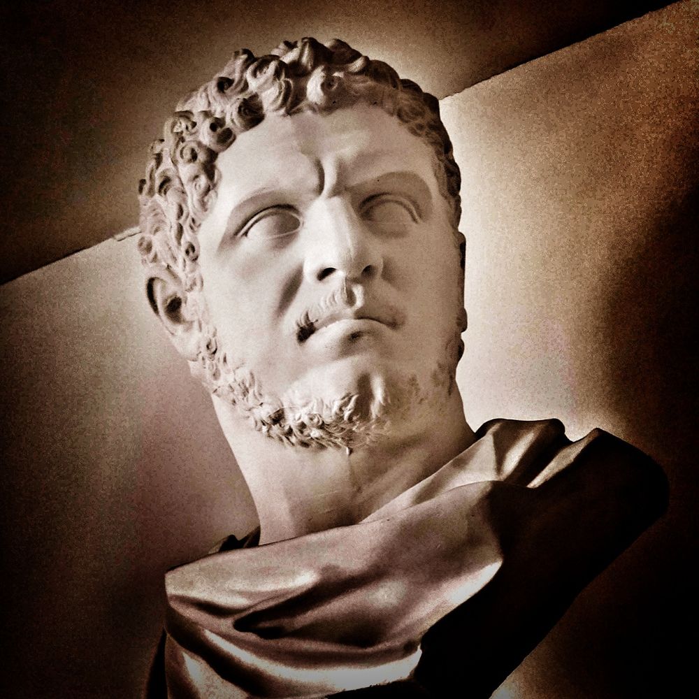 Bust of the Roman emperor Caracalla shot from below and with dramatic lighting to emphasize the dynamism of his contracted forehead and leftward turn of the head.