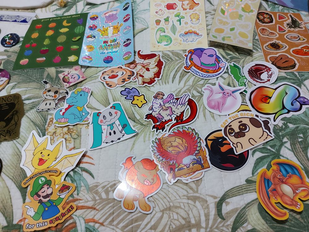 A variety of stickers and sticker sheets depicting fruits and food, Pokémon, animals, Kirby, chimera!Falin and Luigi.
