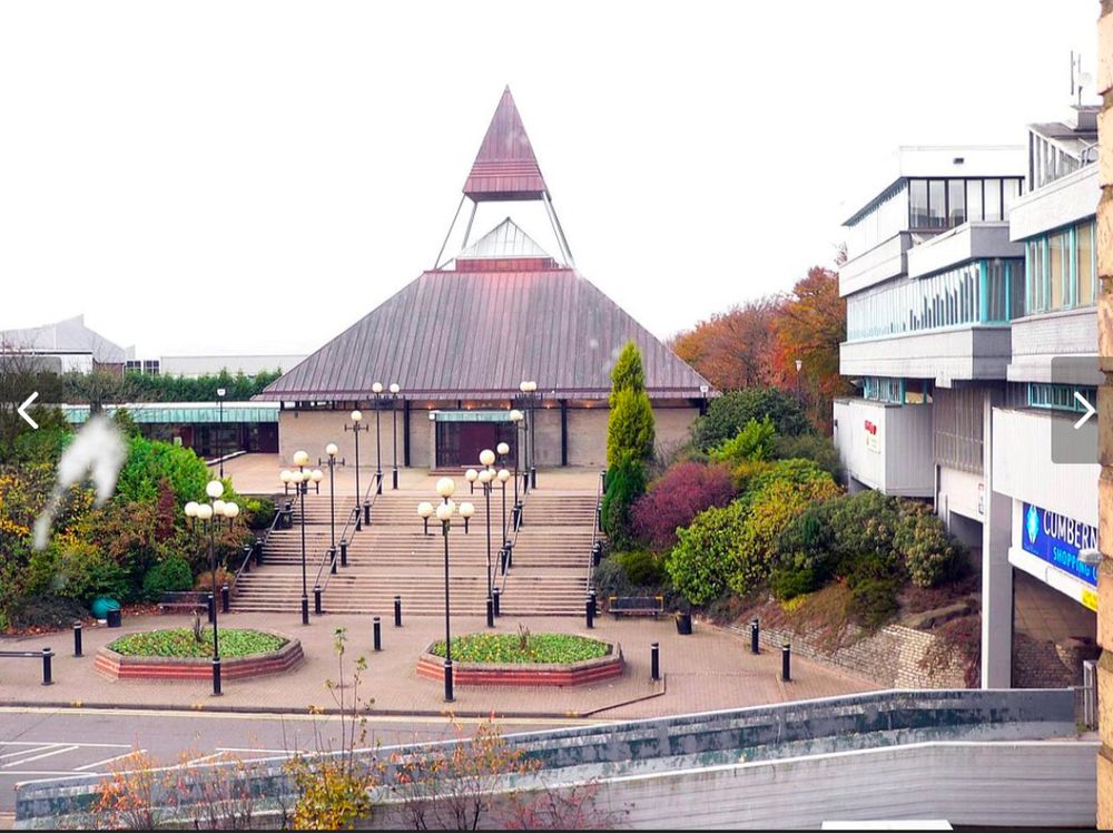 St Mungo's Church, Cumbernauld. Modern construction. Church is square, roof is pyramidal. The peak is glass, and an abstract spire rises above it.