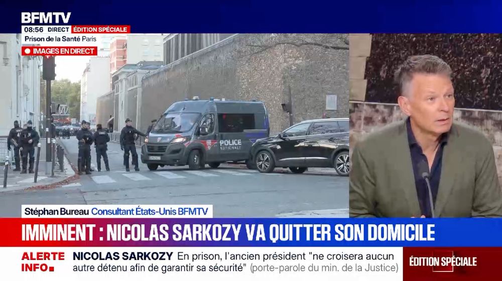 Stephan Bureau, “consultant États-Unis BFMTV” sur le plateau de la chaîne info. Sur les trois quarts gauche de l'écran, vue de la prison de la Santé avec des policiers devant. Bandeau “Imminent : Nicolas Sarkozy va quitter son domicile”.l’endroit de la France : le braquage au Louvre, le braquage des socialistes sur la macronie, l’épisode Lecornu…”