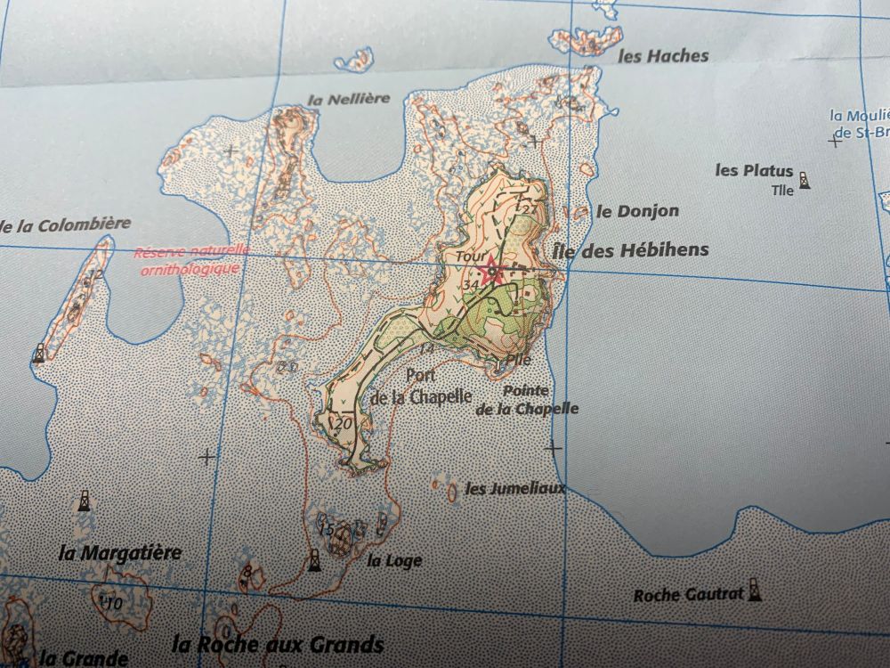 Sur une carte topographique, les lignes indiquent plusieurs altitudes ou profondeurs. Le contour de l’île correspond à la marée haute de coefficient 120.