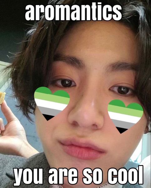 Closeup Jungkook selca with pouty face, aromantic pride hearts on his cheeks and text that says "aromantics you are so cool"