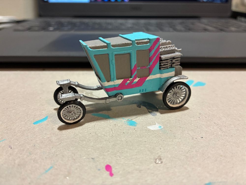 Finished Mikumobile Pic 1. A Coupris Kineema painted teal with white and pink decals and silver highlights.